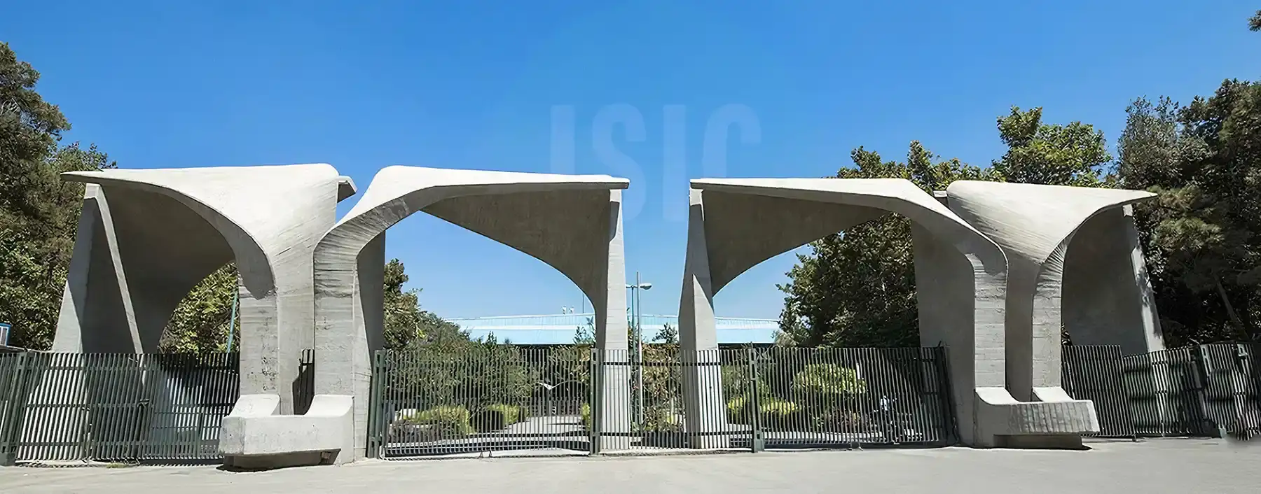 سردر قدیمی و تاریخی دانشگاه تهران که نماد آموزش عالی ایران است و در قالب 4 قطعه طراحی شده و ورودی دانشگاه است و نرده‌هایی جلوی آن را گرفته‌اند و پشت آن، فضای داخلی دانشگاه به چشم می‌خورد
